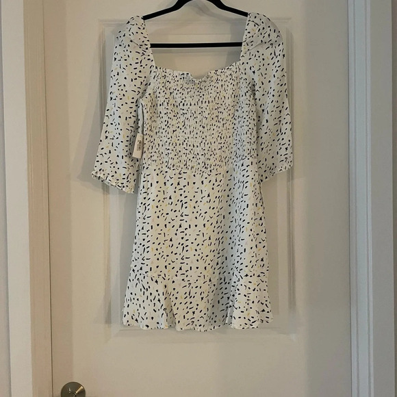 Elegant White and Black Polka Dot Mini Dress - Picture 6 of 8